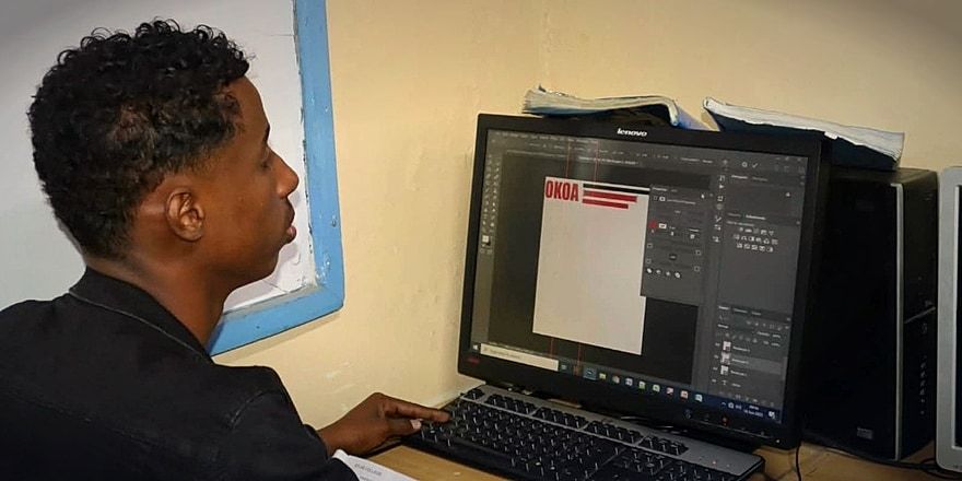 Atlas College graphic design student working on creative project